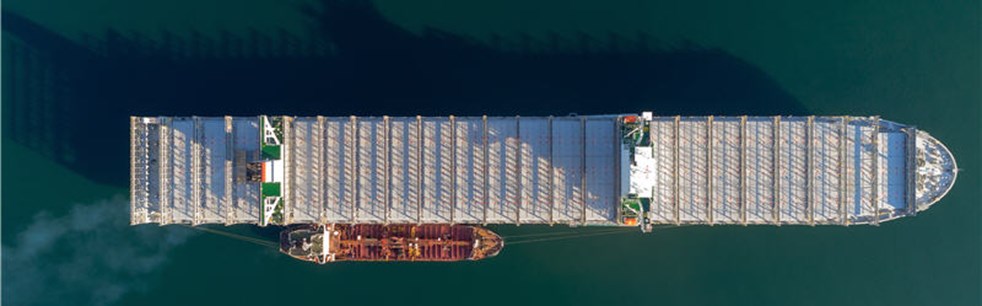Top view of a large empty container ship and a tanker standing side by side